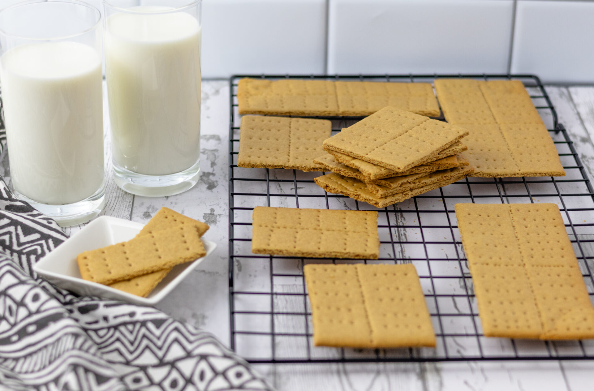Golden brown homemade graham crackers cut into squares and stacked neatly —whole food plant-based, oil-free, and toddler-friendly.